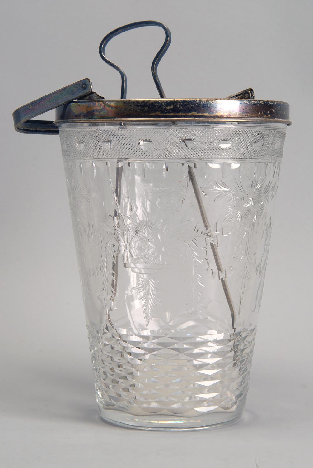 Appraisal: CUT GLASS HANDLED ICE BUCKET with tongs Silver rim marked