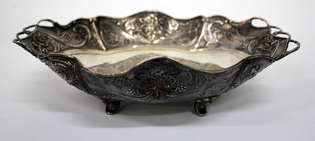 Appraisal: A WHITE METAL DISH with foliate decoration and pierced edge