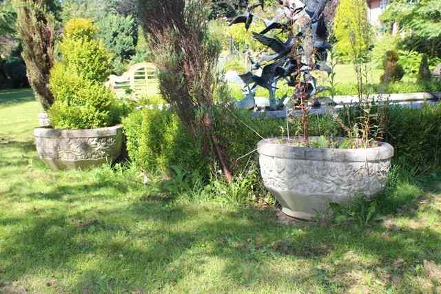 Appraisal: A PAIR OF HADDONSTONE SHALLOW PLANTERS with faceted sides and