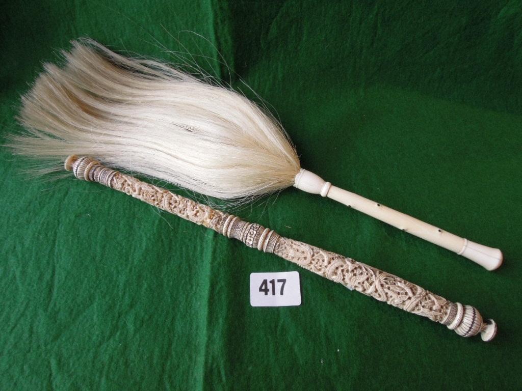 Appraisal: A fly swish with turned ivory handle and a carved