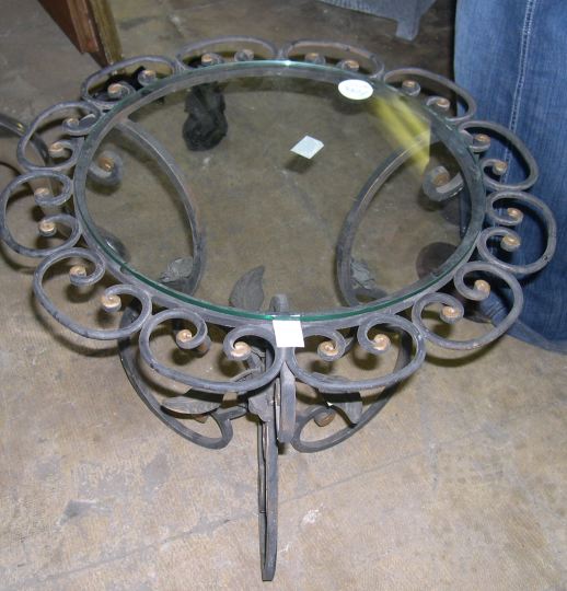 Appraisal: Glass and Wrought-Iron Garden Table the circular glass top within