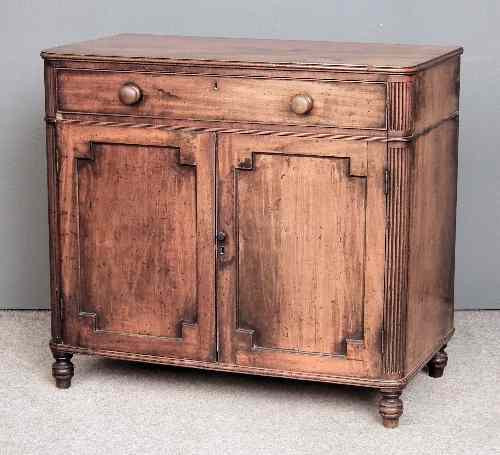 Appraisal: A late Georgian mahogany side cabinet with rounded and reeded