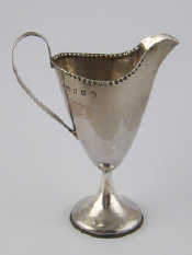 Appraisal: A Georgian silver helmet cream jug with strap handle and