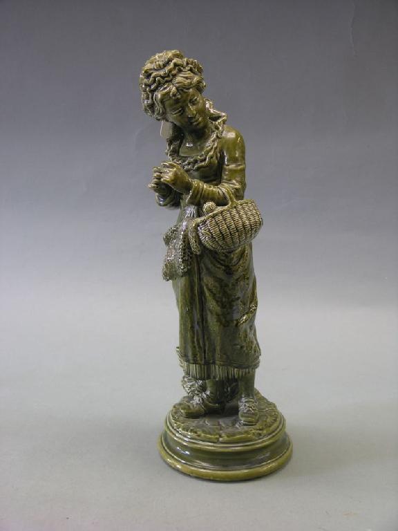 Appraisal: A th century green glazed earthenware statuette of a lady