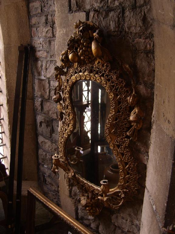 Appraisal: A th century gilded leather wall mirror of shaped form