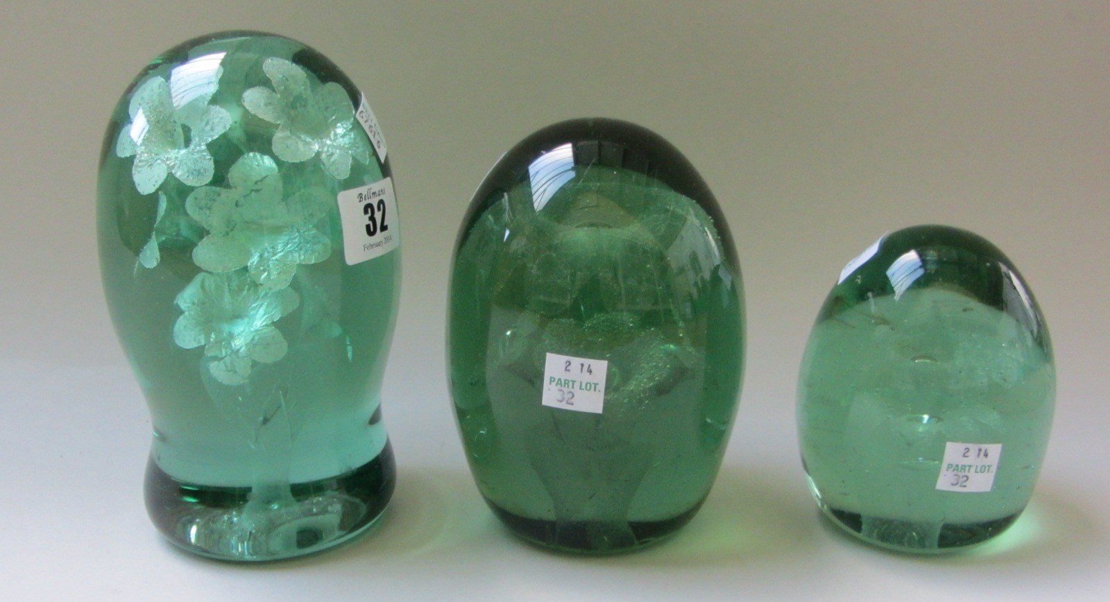 Appraisal: Three Victorian green glass dump paperweights with floral inclusions cm