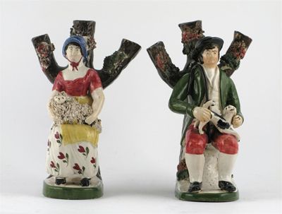 Appraisal: A pair of Scottish Portobello-type pearlware figures modelled as a