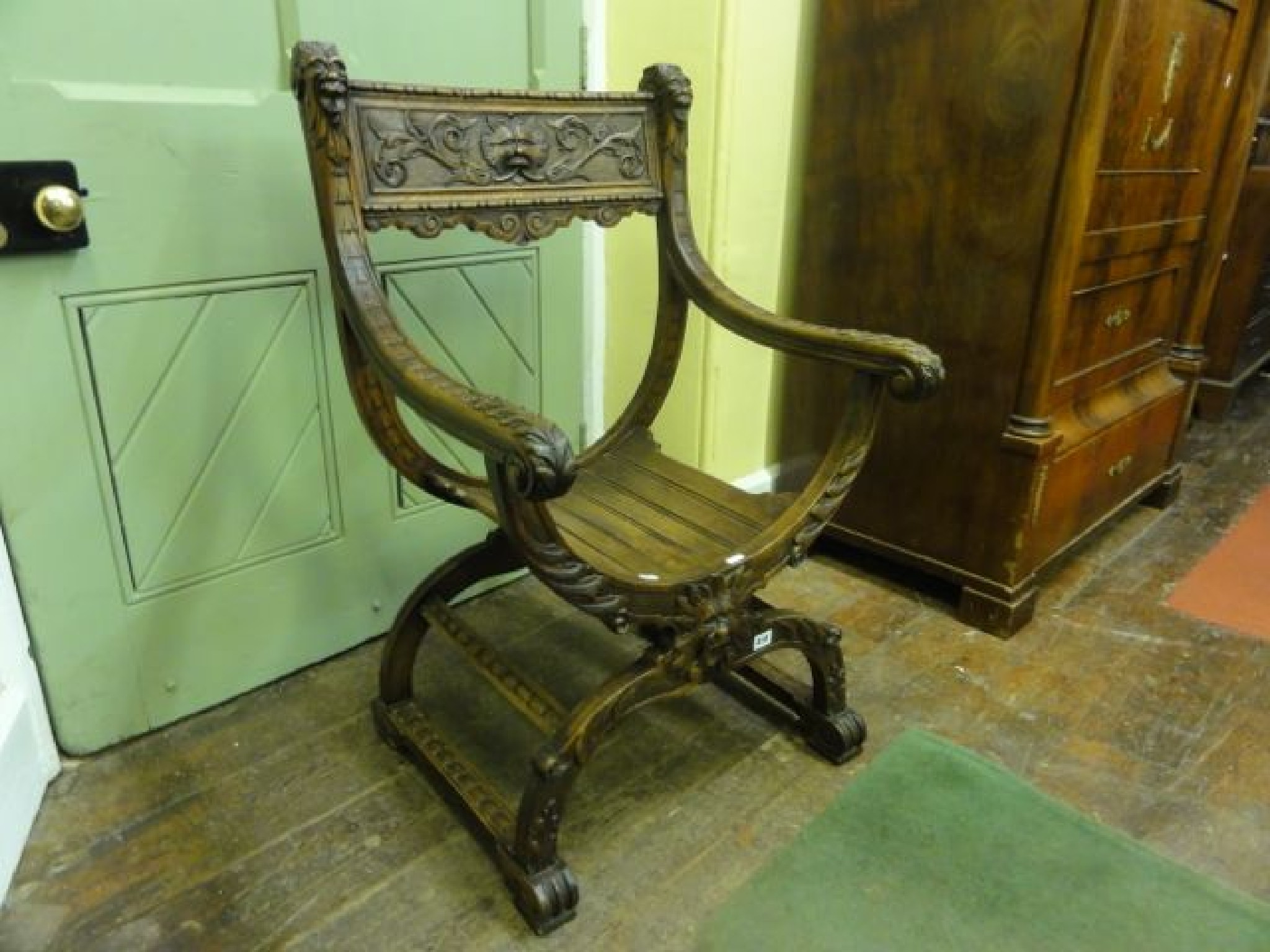 Appraisal: A th century walnut X frame chair with carved green