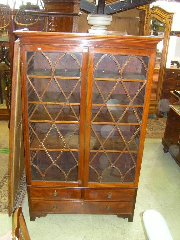 Appraisal: A th century mahogany display cabinet enclosed by two glazed