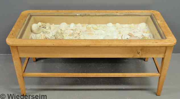 Appraisal: Blonde wood curio cased coffee table with seashell collection h