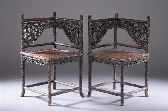 Appraisal: PAIR CHINESE ROSEWOOD CORNER ARMCHAIRS th century Carved with cherry