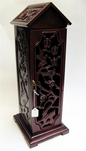 Appraisal: MAHOGANY TABLE TOP NETSUKE SNUFF BOTTLE CABINET The pierced-carved swing