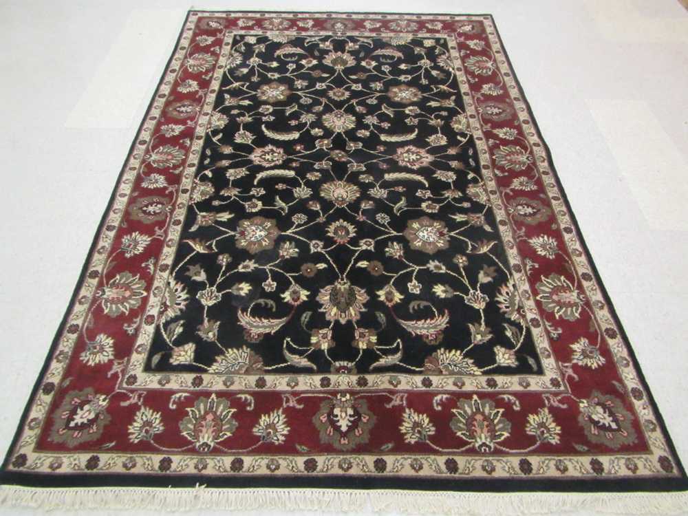 Appraisal: HAND KNOTTED ORIENTAL CARPET Indo-Persian scrolling floral raceme design on