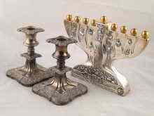 Appraisal: A silver cased menorah cm across and a pair of