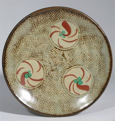 Appraisal: A stoneware dish by Tatsuzo Shimaoka painted with with three