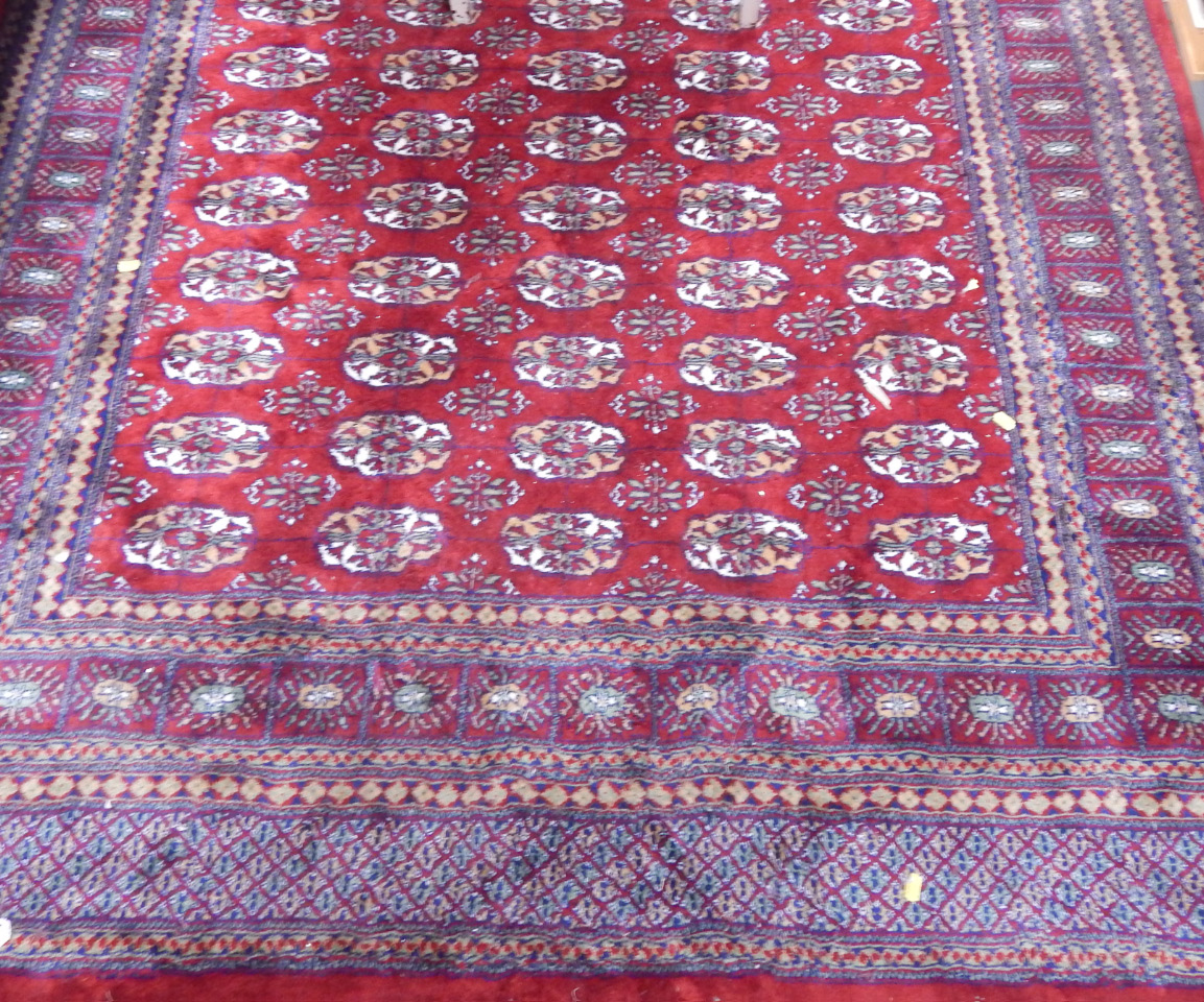 Appraisal: A Shiraz red ground rug decorated with floral medallions cm