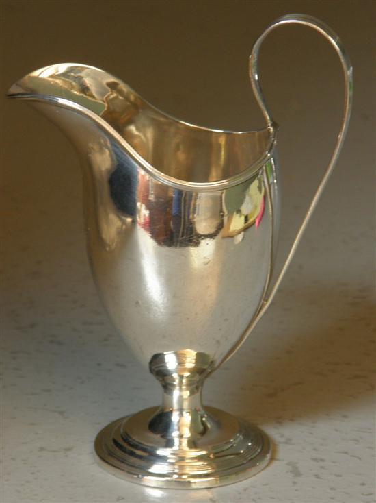 Appraisal: George III silver cream jug with hoop handle on round