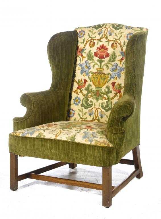 Appraisal: A MAHOGANY ARMCHAIR with wing back and overscrolled arms upholstered