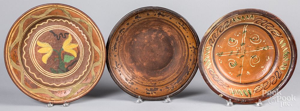 Appraisal: Three redware chargers th c Three redware chargers th c