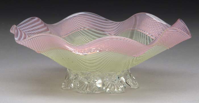 Appraisal: ART GLASS FOOTED BOWL Clear glass with white drag loops