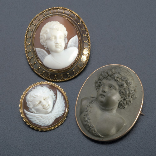 Appraisal: Three putti or cherub cameo brooches with gold mounts ca