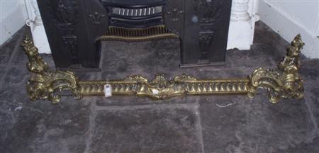 Appraisal: A pair of Rococo style brass chenets and a fender