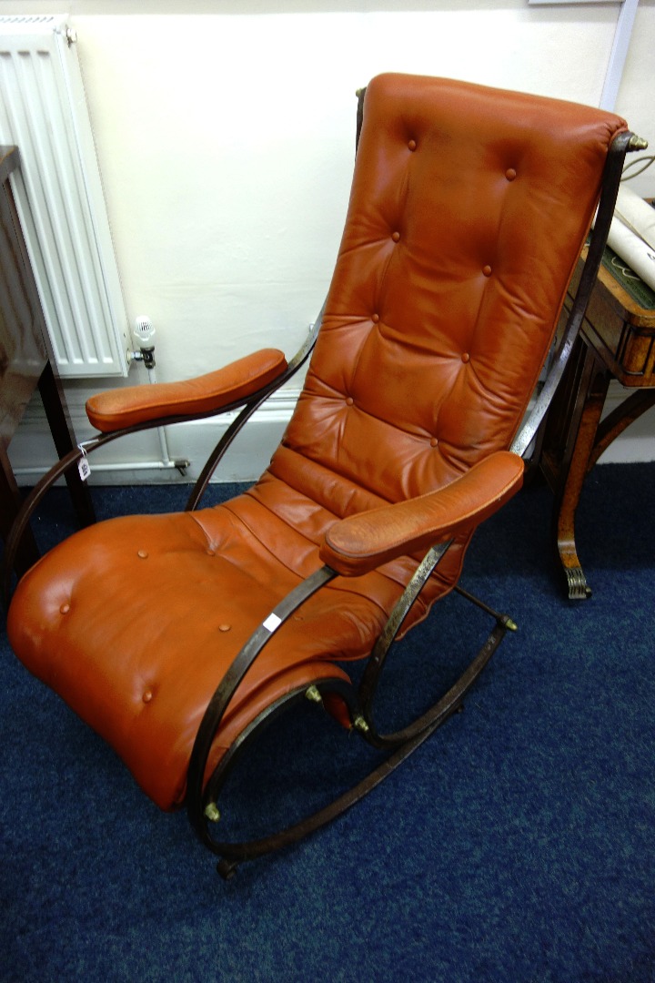 Appraisal: A wrought metal rocking chair th century button down upholstered