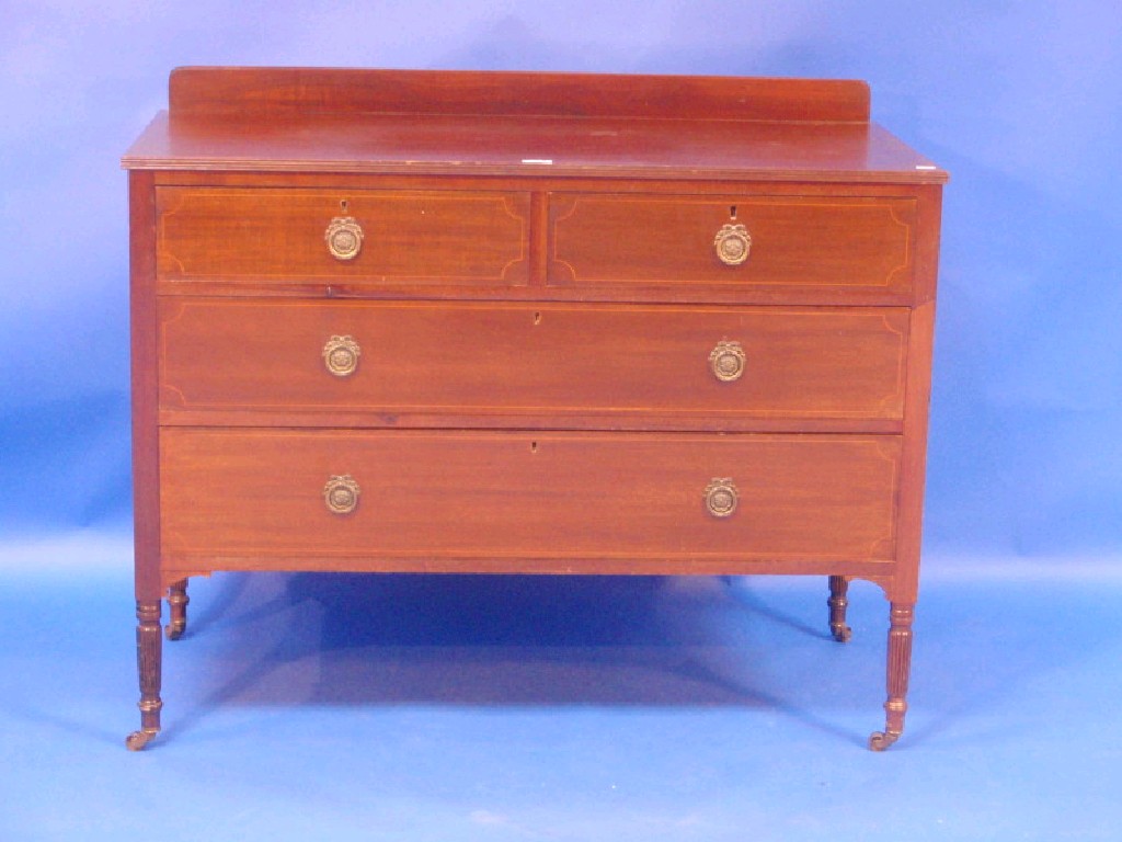 Appraisal: An Edwardian mahogany four drawer chest on reeded legs cm