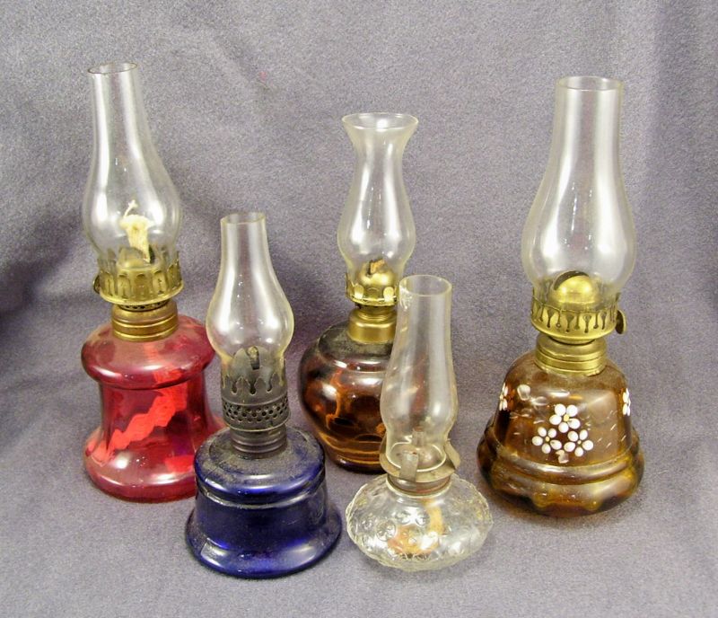 Appraisal: - Miniature Kerosene Lamps Includes Amber base with a reverse