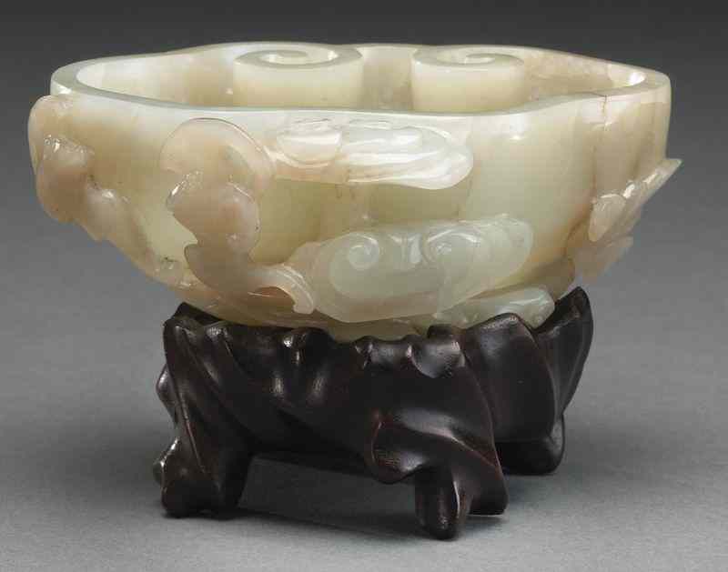 Appraisal: Chinese Qing Qianlong carved jade brush washerhaving a ruyi shape