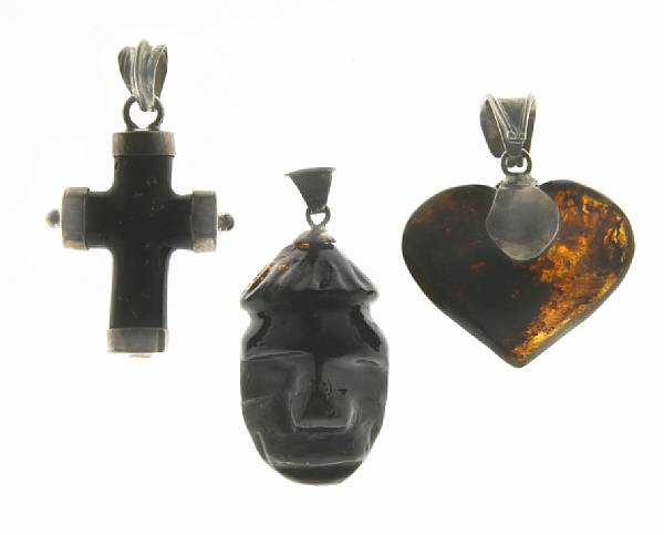 Appraisal: Three Carved Black Amber Pendants Dominican Republic Three pendants artfully