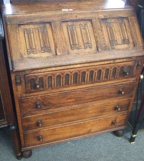 Appraisal: A mid th century oak bureau the linen fold carved