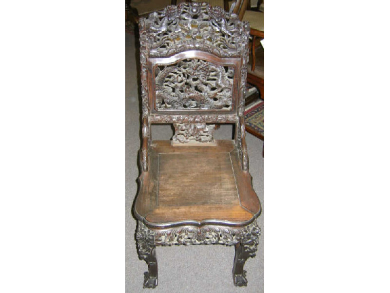 Appraisal: CHINESE HARDWOOD SIDECHAIR Elaborately carved back incorporating dragons and scrolling