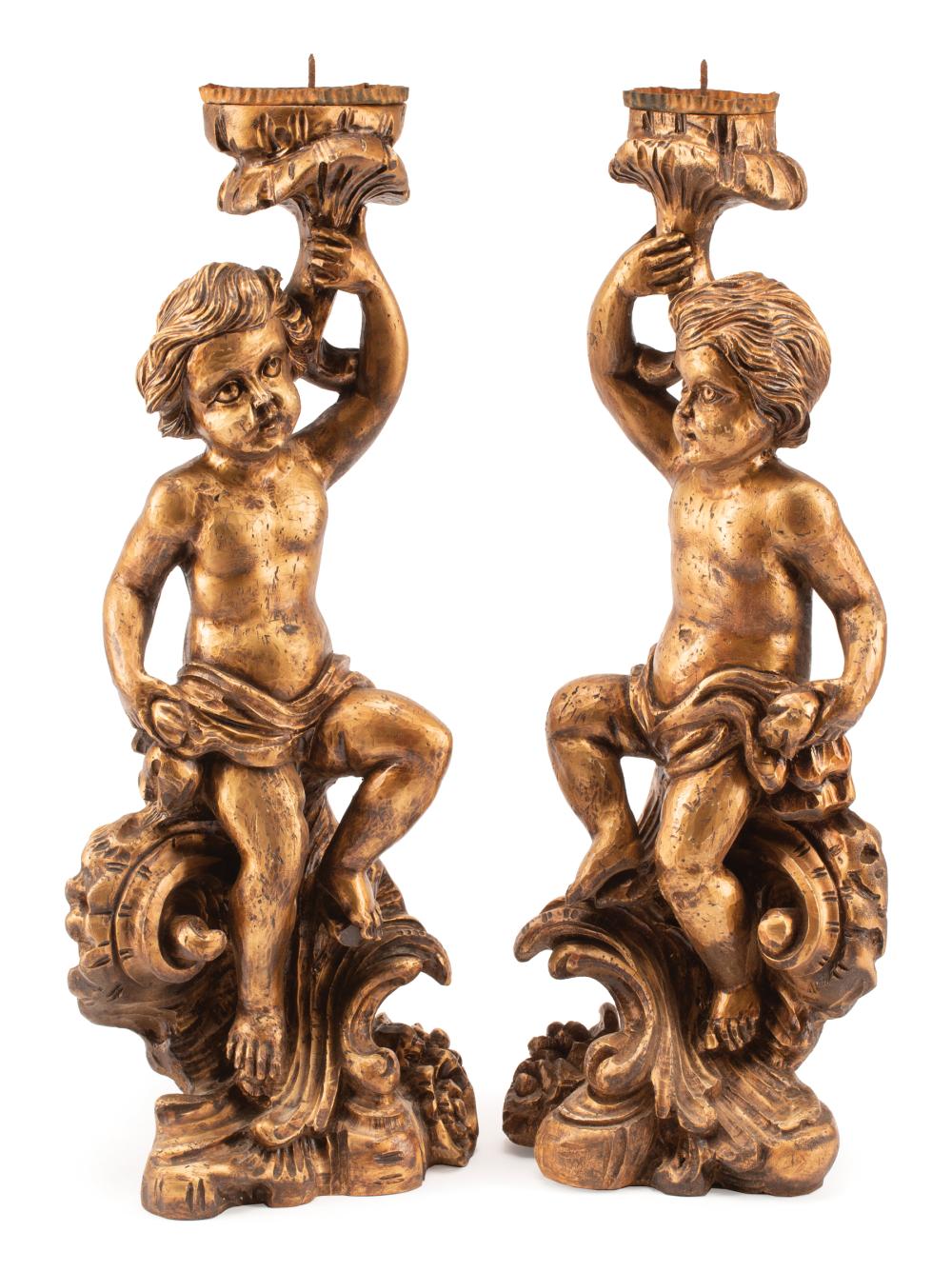 Appraisal: Pair of Italian Rococo-Style Carved Giltwood Figural Prickets cherub and