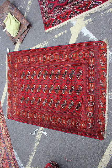 Appraisal: AN OLD WINE GROUND BALUCHI RUG with three rows of