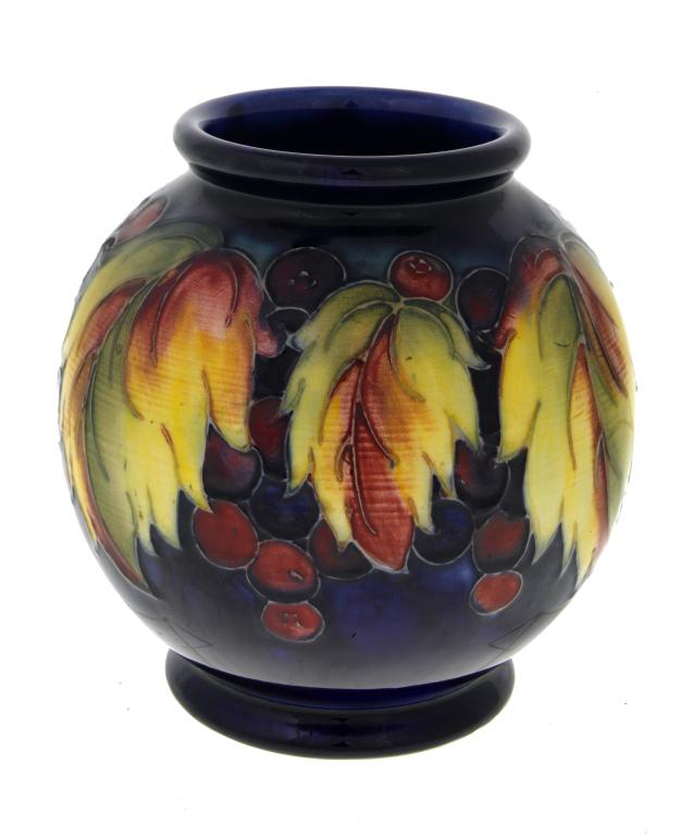 Appraisal: A MOORCROFT GRAPE AND LEAF GLOBULAR VASE DESIGNED BY WILLIAM