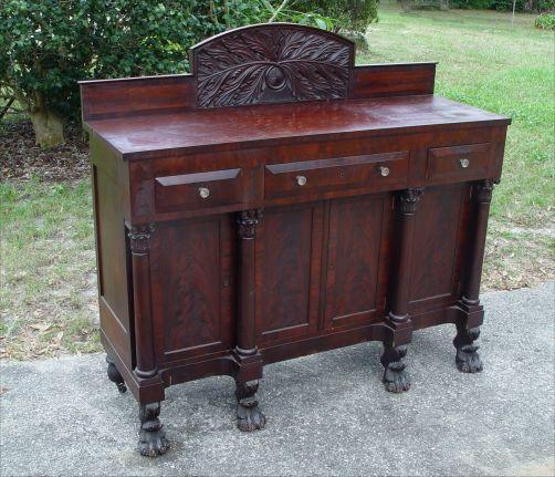 Appraisal: AMERICAN EMPIRE PERIOD SIDEBOARD Featuring Carved crest and four columnar