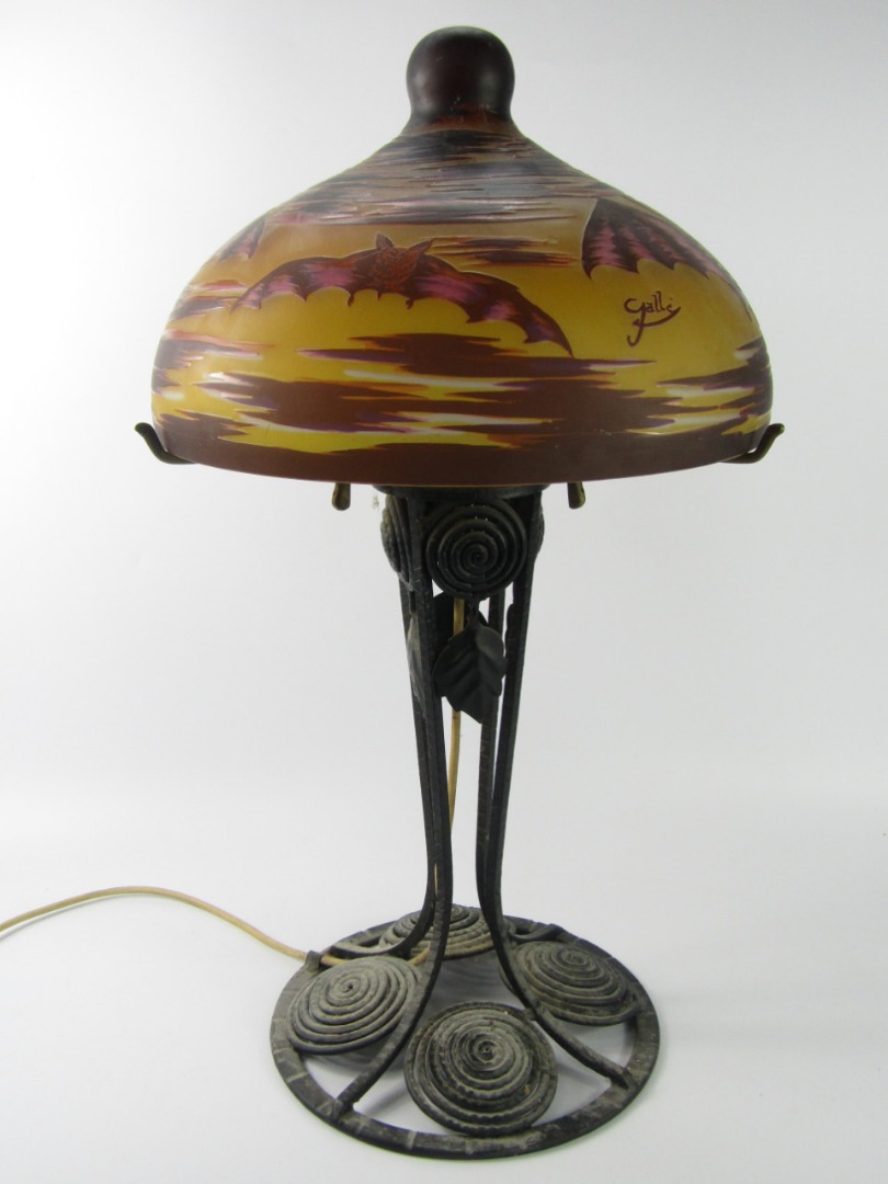 Appraisal: A Galle style cast iron table lamp with glass shade