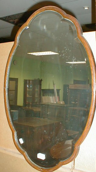 Appraisal: A shaped and beveled wall mirror