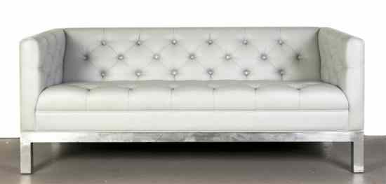 Appraisal: A Leather Upholstered Settee the button tufted back raised on