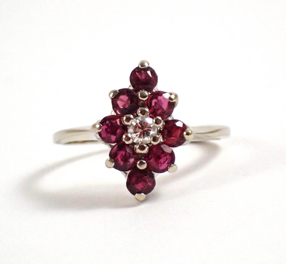 Appraisal: DIAMONDS RUBIES AND FOURTEEN KARAT WHITE GOLD RING featuring a