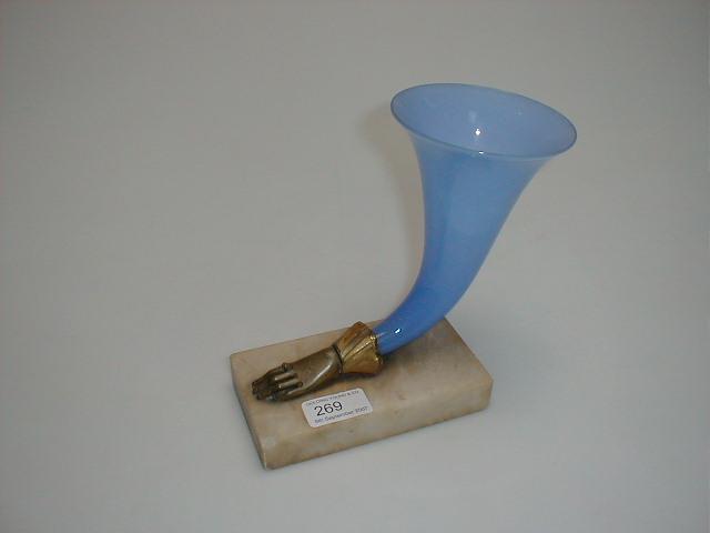 Appraisal: A thC blue glass cornucopia issuing from a cast metal