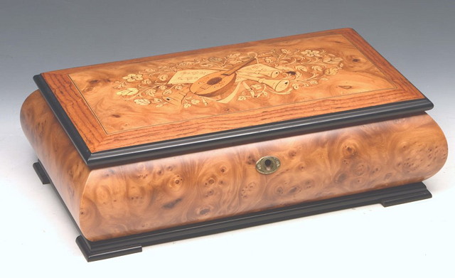 Appraisal: A MODERN WALNUT JEWELLERY BOX of shaped rectangular form the