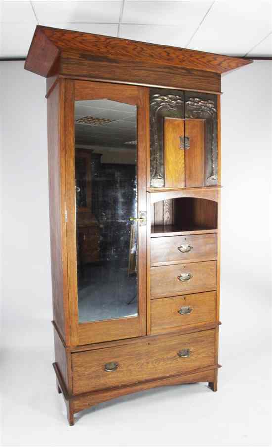 Appraisal: An Arts Crafts oak wardrobe with mirrored door and two