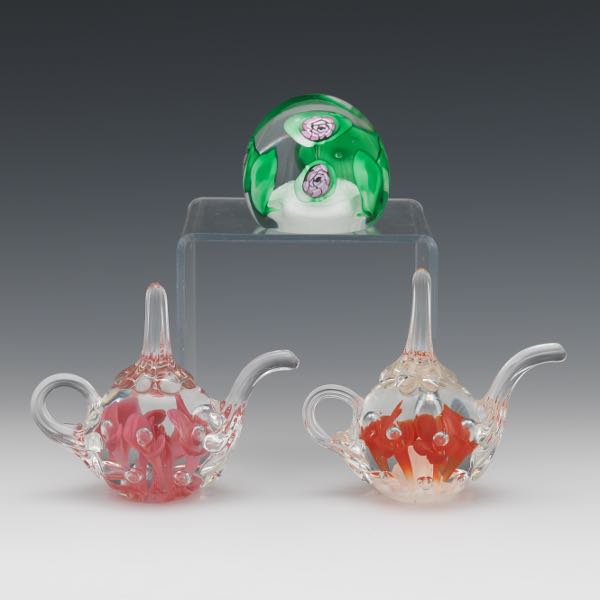 Appraisal: THREE GLASS PAPERWEIGHTS Two Joe St Clair teapot paperweights approximately