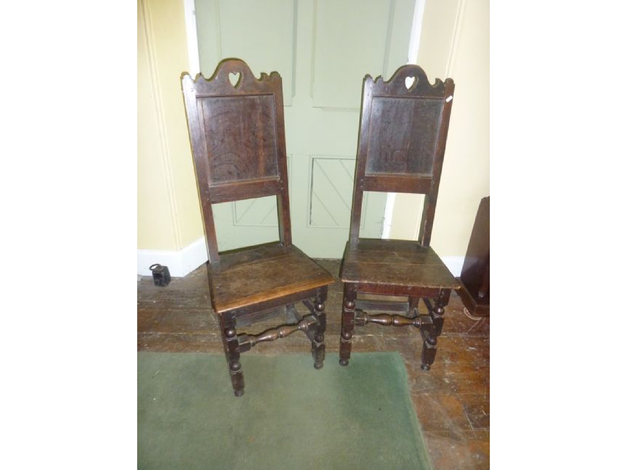 Appraisal: A pair of early oak hall chairs probably Welsh with