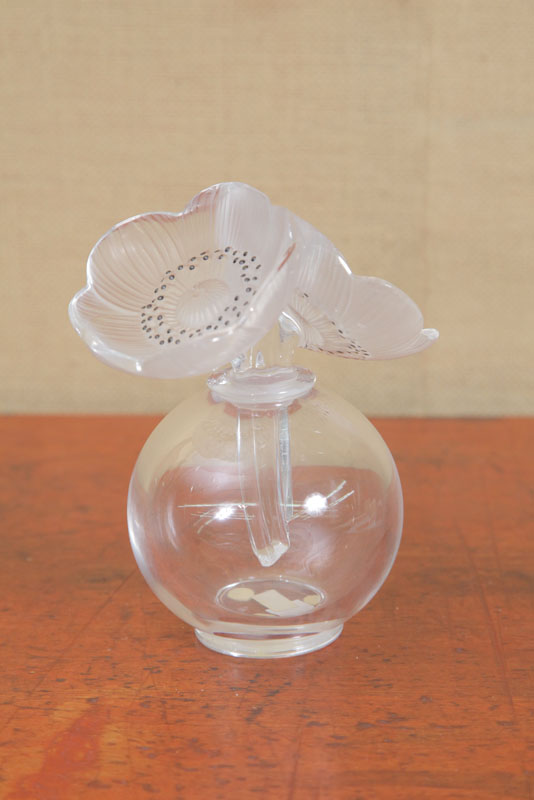 Appraisal: LALIQUE PERFUME Clear bulbous body having a frosted floriform lid