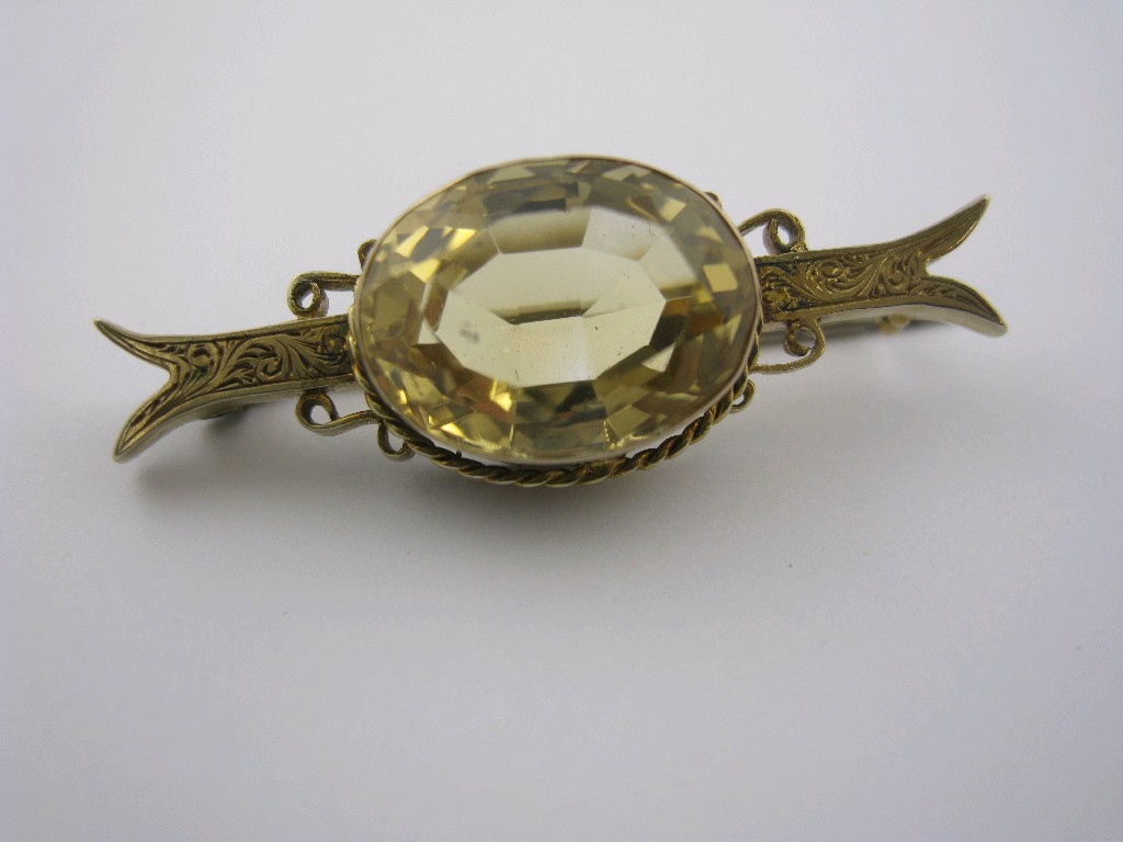 Appraisal: A Citrine Brooch collet-set oval-cut stone within rope twist form