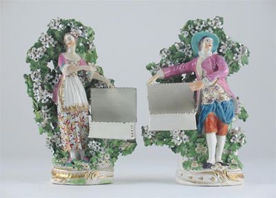 Appraisal: A pair of Derby sweetmeat figures each beside a rectangular