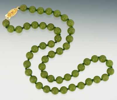 Appraisal: Jade Necklace Uniform strand of mm green beads with yellowish